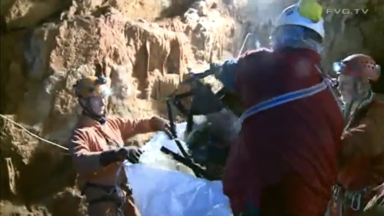 Cavers picking up junk fromthe bottom af the cave