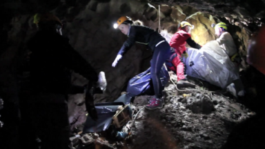 People cleaning cave