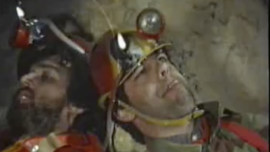 2 men in a cave with helmets